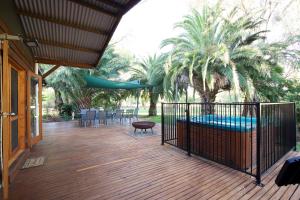 a large deck with a hammock and a swing at Goolwa River Retreat in Torrumbarry