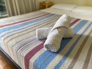 a white towel laying on top of a bed at Vina Rio in Rio de Janeiro