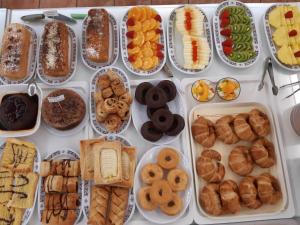 a table full of different types of bread and pastries at Hotel Finca La Mansión in Llanes