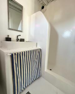 a bathroom with a sink and a mirror at Serifos White in Serifos Chora