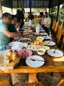 a long wooden table with plates of food on it at Dil Hill by Sam in Dilijan