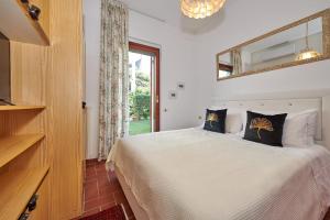 a bedroom with a large bed with a window at Apartments Rainer - Front Lake in Bardolino +62 photos