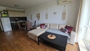 a living room with a couch and a table at Atia Resot in Chernomorets