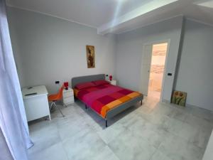 a bedroom with a bed and a desk and a chair at B&B Santa Colomba in Benevento