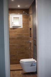 a bathroom with a toilet and a glass shower at Mediterranean Escape in Flogita