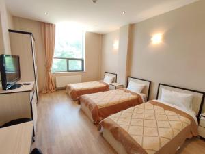 A bed or beds in a room at Gabala Qoruq Resort