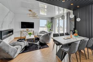 a living room with a table and chairs at Luxury Voyager - Sea View in Gdańsk