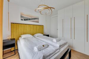 a bedroom with a large bed with two towels on it at Luxury Voyager - Sea View in Gdańsk +13 photos