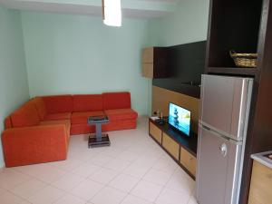 un soggiorno con divano e TV di Family Beach 100 Square Metres Apartment a Golem
