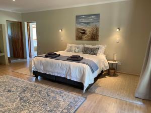 a bedroom with a bed with two towels on it at Summerplace Game Reserve in Vaalwater