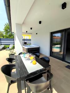 jadalnia ze stołem i krzesłami w obiekcie Villa VINE - new luxury holiday house in a green oasis w mieście Manjadvorci