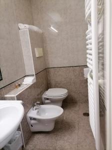 a bathroom with a white toilet and a sink at Partenone Resort Hotel in Riace Marina