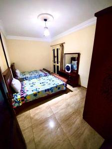 a bedroom with a bed and a mirror at شقة بأطلالة علي الشاطئ in Alexandria