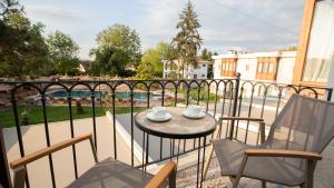 a balcony with a table and chairs and a view of a pool at Balturk Garden Sapanca Hotel in Sapanca