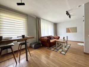 a living room with a couch and a table at DEUXx rooms in Liepāja