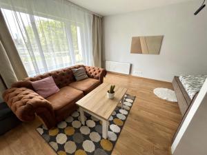 a living room with a couch and a table at DEUXx rooms in Liepāja +20 photos