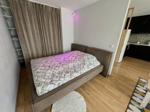 a small bedroom with a bed and a book shelf at DEUXx rooms in Liepāja
