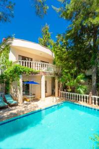 a villa with a swimming pool and a house at BG Villas & Aparts in Kas