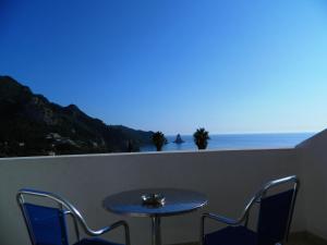 
a dining room table with a view of the ocean at Panorama Hotel in Agios Gordios
