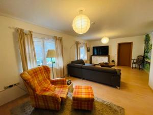 a living room with a couch and a chair at Ferienhaus Straupitz-Spreewald mit Sauna in Straupitz