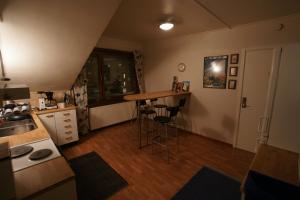 a kitchen with a table and stools in a room at Park Hotell in Luleå