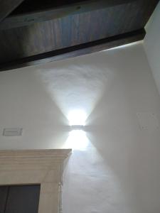 a light in a room with a white ceiling at Tiny House Alferi in LʼAquila