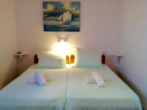 a bedroom with two beds with towels on them at Seatinview Lodges in Mikonos +48 photos