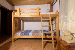 a wooden bunk bed with a teddy bear sitting next to it at Marin Holiday in Dhaskalión