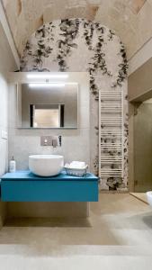 a bathroom with a sink and a mirror at Palazzo Palasciano in Monopoli