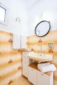 a bathroom with a sink and a mirror at Anna's House in Xerokampos +22 photos