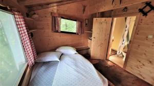 a small room with a bed in a cabin at Treehouse Toplak in Ruše