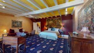 a bedroom with a bed and a desk in a room at Château du Chambon in Cerzat +9 photos