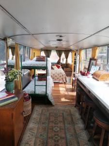 a room with a bedroom and a bed in a van at Green Bus unique & private 3 min from Coral Bay in Akoursos