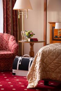 a hotel room with a bed and a suitcase at Grand Hotel Bucharest in Bucharest