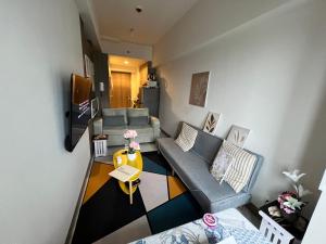 マニラにあるBeautiful 1bed condo Nr Airport, MOA, Makati, Bayのソファとテーブルのあるリビングルーム
