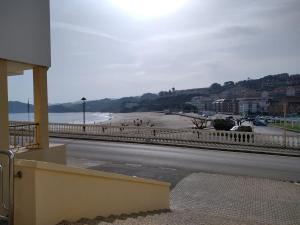 a view of a beach and the ocean from a building at Pensión Vega de Pas in Comillas +14 photos