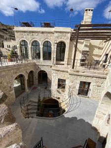 a large stone building with a large courtyard at Ürgüp Cave Suites in Urgup