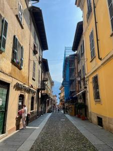 an empty street in a city with buildings at Sweet Dreams in Cannobio