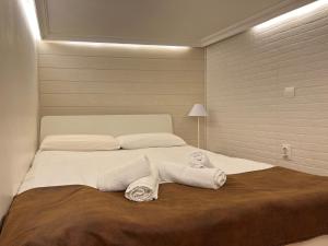 a bedroom with a large white bed with towels on it at Mini duplex plaza mayor in Madrid