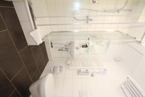 a bathroom with a sink and a toilet in it at Apartment Hotel am Sand in Hamburg +34 photos