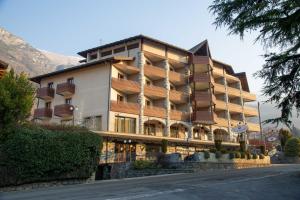 a large building with balconies on the side of a road at Relais Du Foyer in Châtillon