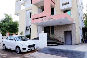 a white car parked in front of a building at Hotel Annapura Residency, Chalisgaon in Chālisgaon
