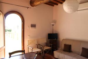 a living room with a couch and a table at Agriturismo Poggio Agli Ulivi in Riotorto