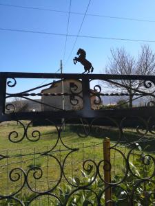 a statue of a dog on top of a fence at Villa Vecchio Ulivo in Sarconi