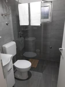a bathroom with a white toilet and a shower at Lahor in Bihać