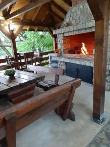 a picnic table and a fireplace in a pavilion at Lahor in Bihać +36 photos