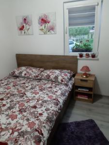 a bedroom with a bed and a window at Lahor in Bihać