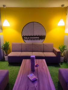 a living room with a couch and a table at Procida Hostel by Zero Jhanjhat in Pune