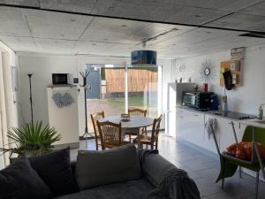 a living room with a couch and a table in a kitchen at studio 2 personnes in Luxeuil-les-Bains