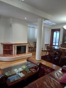 a living room with a couch and a fireplace at Francelos Village in Vila Nova de Gaia